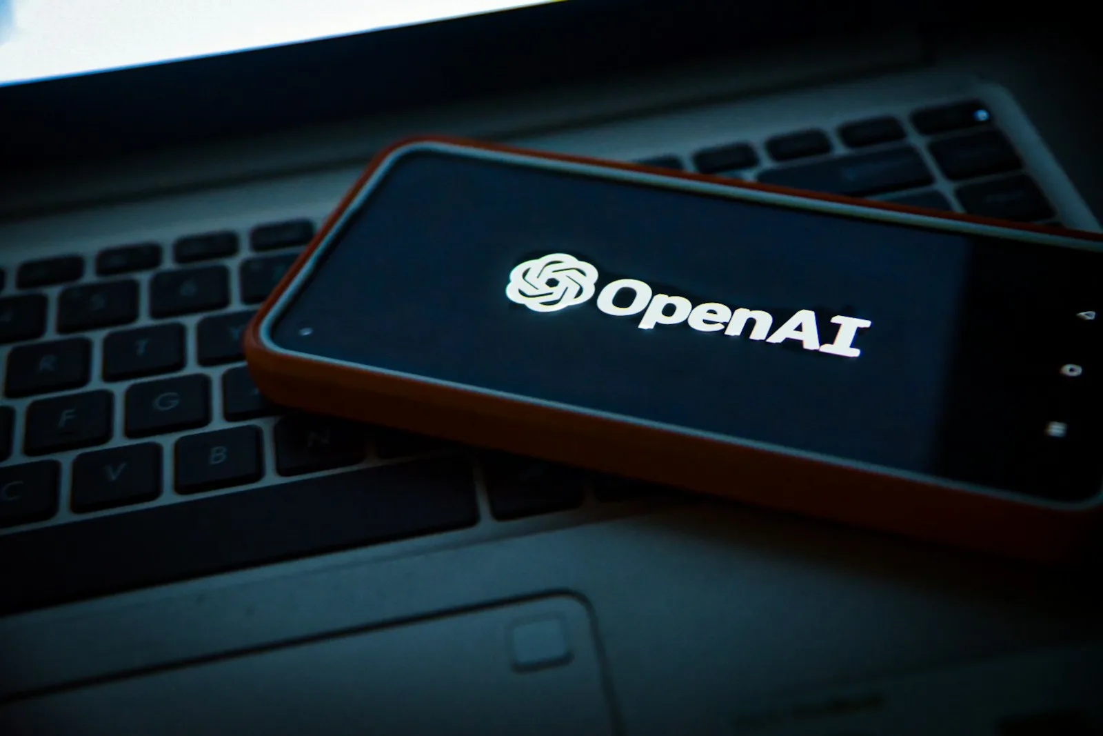 OpenAI logo on a smartphone screen placed on a laptop, introducing OpenAI Dots AI agent