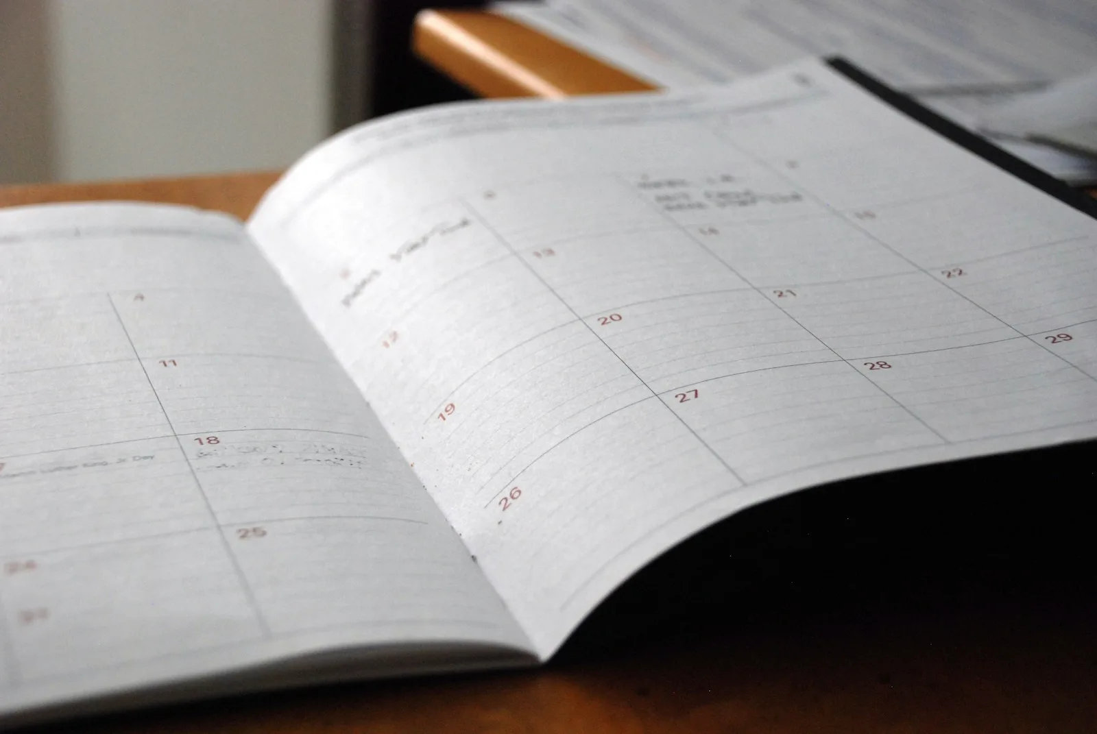Open planner on a desk representing team coordination with Dots through Slack and Microsoft Teams