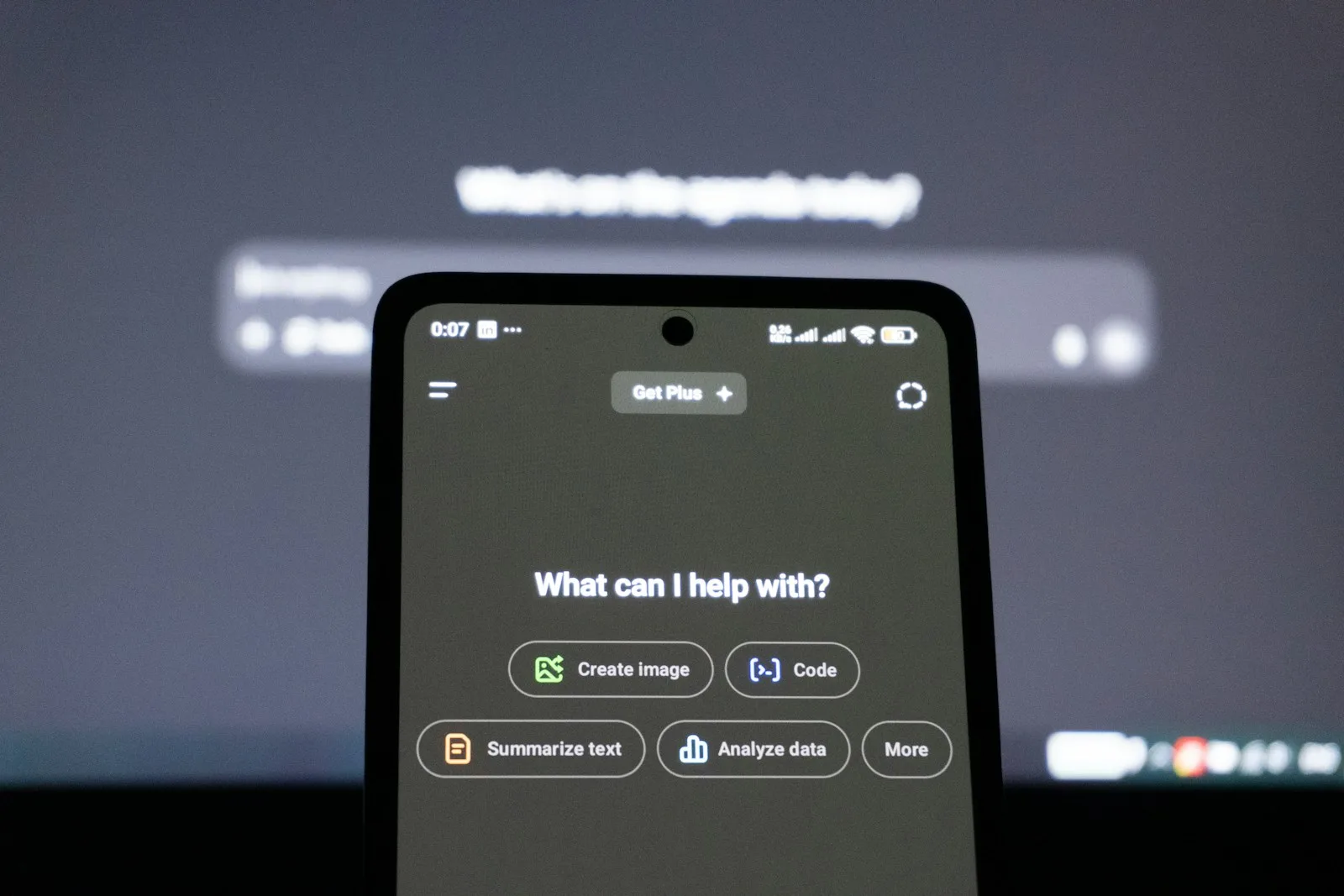 AI assistant app on a smartphone asking what it can help with, showing how AI agents handle everyday tasks