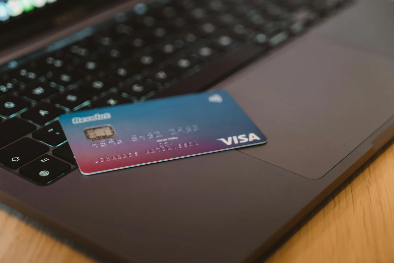 Credit card resting on a laptop keyboard for an online payment