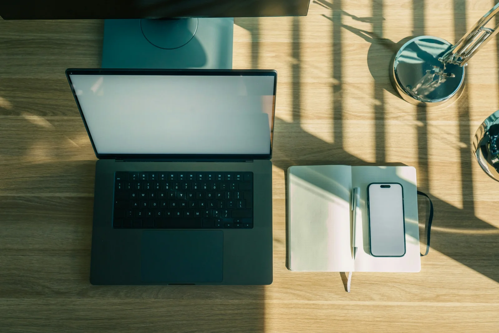 Laptop, smartphone and notebook on a desk used to review a customer support exchange